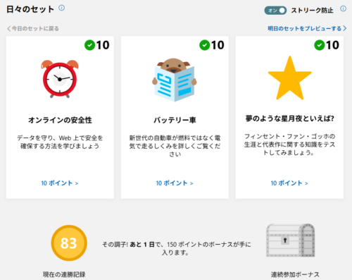 「日々のセット（デイリーセット）」画面。 表示されているミッションは、「オンラインの安全性」「バッテリー車」「夢のような星月夜といえば？」の3つ。 いずれもポイント獲得済みの緑色チェックマークがついている。 下部には、現在の連勝記録「83」、「その調子！あと1日で、150ポイントのボーナスが手に入ります」と記載されている。